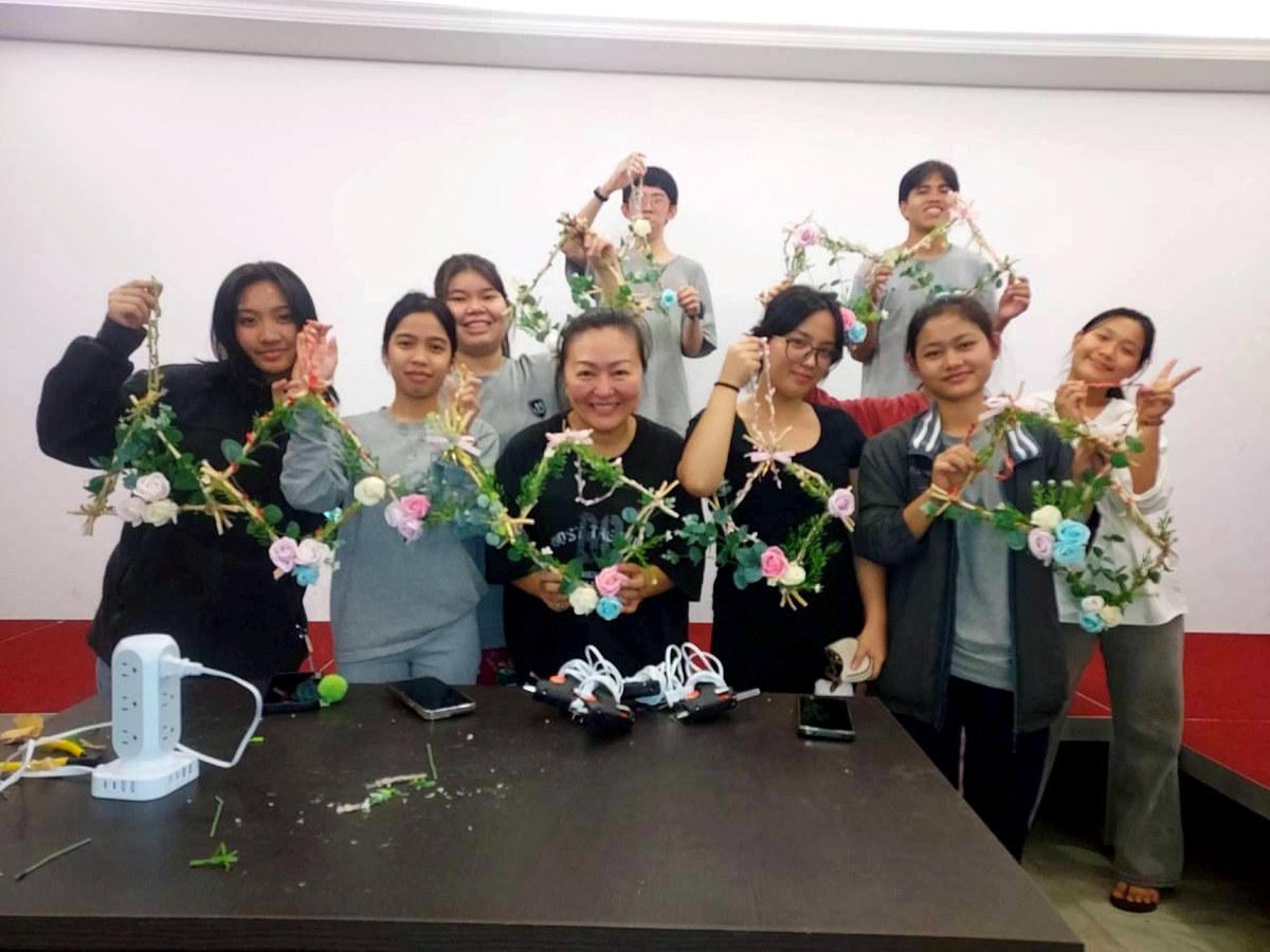 Overseas students and teachers participating in a cultural learning activity